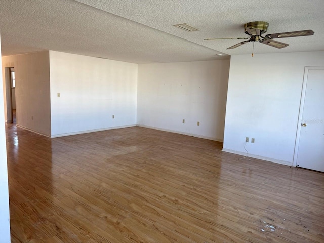 empty room featuring hardwood / wood-style floors, a textured ceiling, and ceiling fan