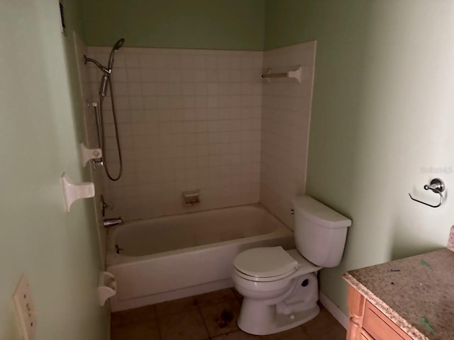 full bathroom with tile patterned floors, vanity, tiled shower / bath combo, and toilet