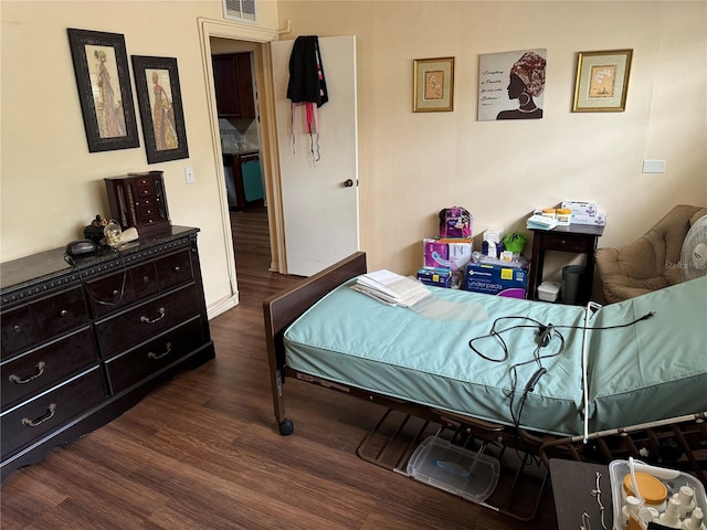 bedroom featuring dark hardwood / wood-style flooring