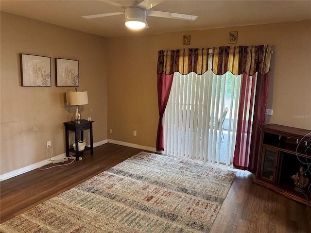 interior space with ceiling fan and dark hardwood / wood-style floors