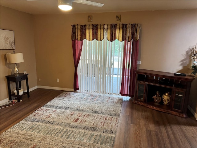 sitting room featuring ceiling fan and dark wood-type flooring