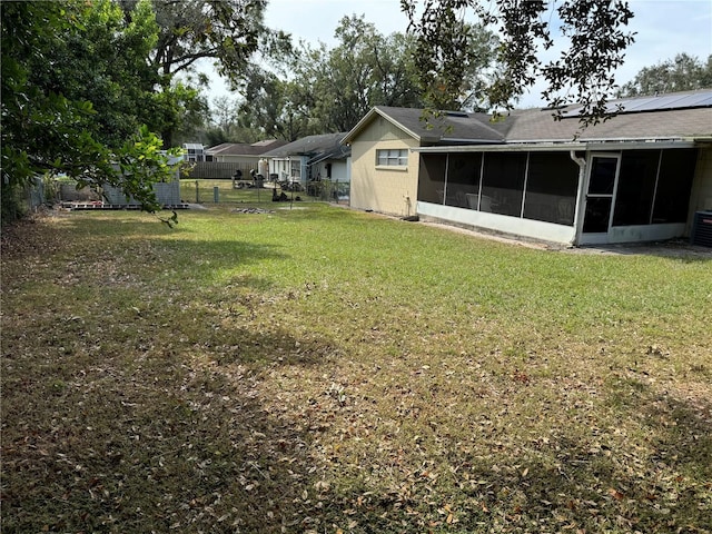 view of yard featuring central AC and a sunroom