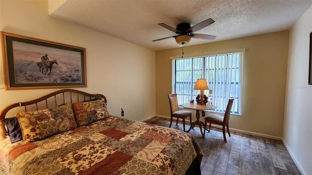 bedroom with ceiling fan, dark hardwood / wood-style flooring, and a textured ceiling