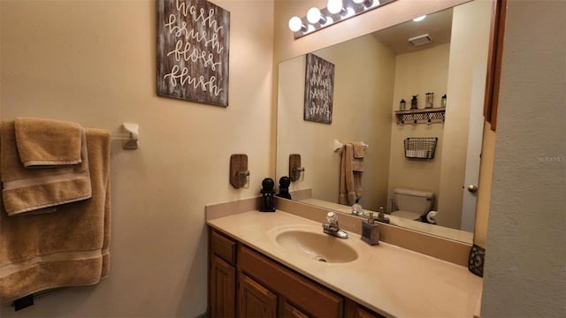 bathroom featuring vanity and toilet