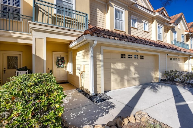 exterior space featuring a garage and a balcony