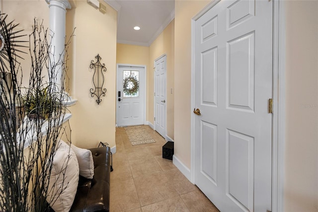 interior space featuring ornate columns, ornamental molding, and light tile patterned flooring