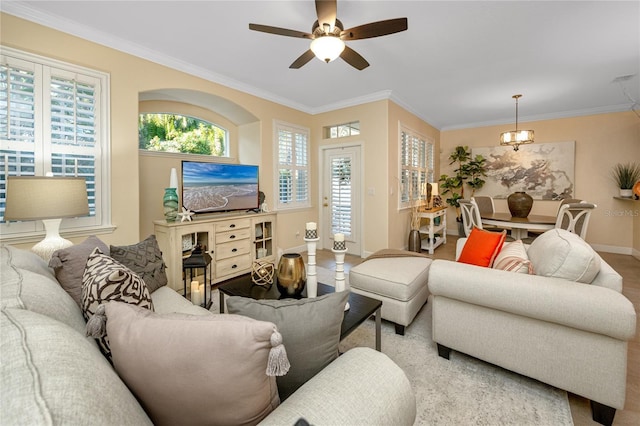 living room featuring ceiling fan and ornamental molding