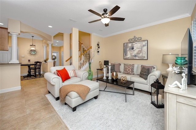 tiled living room featuring ceiling fan, ornate columns, and crown molding