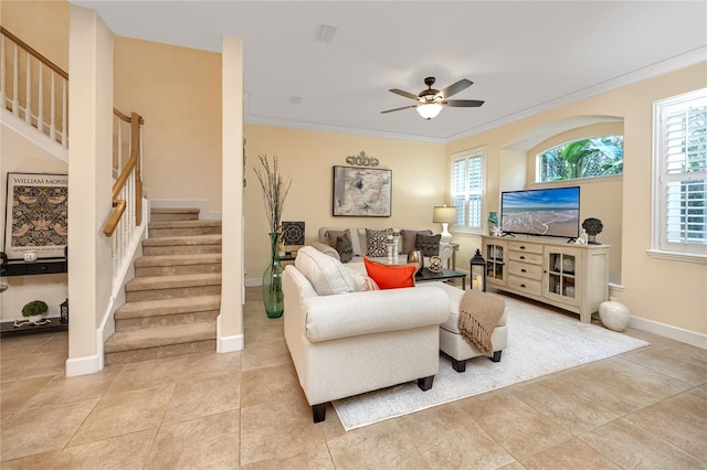 tiled living room featuring ceiling fan and ornamental molding