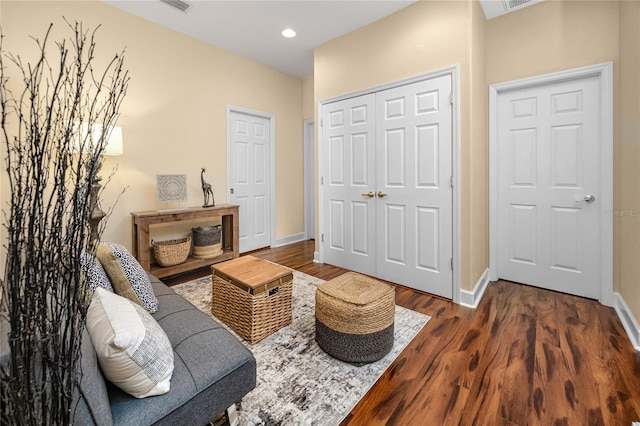 living area with dark hardwood / wood-style flooring