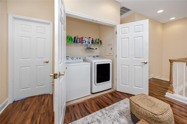 laundry area featuring dark hardwood / wood-style floors and washer and clothes dryer