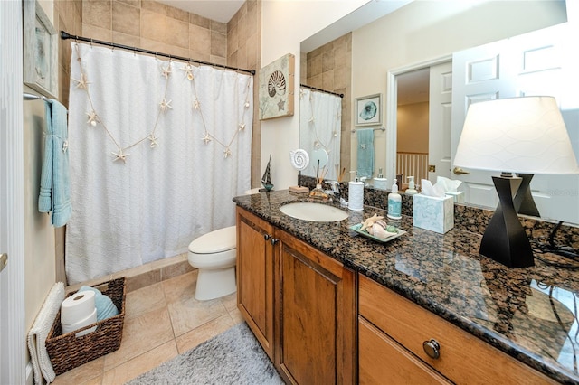 bathroom with tile patterned floors, vanity, and toilet