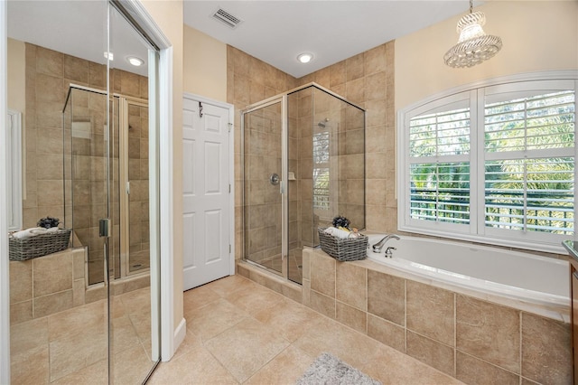 bathroom with tile patterned flooring and separate shower and tub