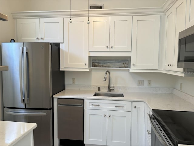 kitchen with sink, white cabinetry, and stainless steel appliances