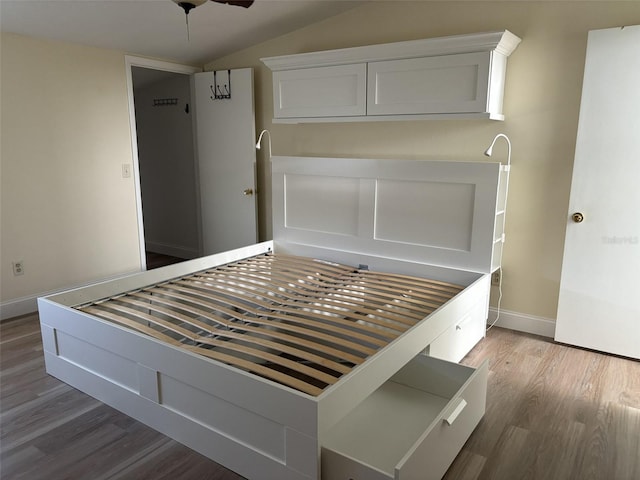 unfurnished bedroom featuring lofted ceiling, ceiling fan, and wood-type flooring