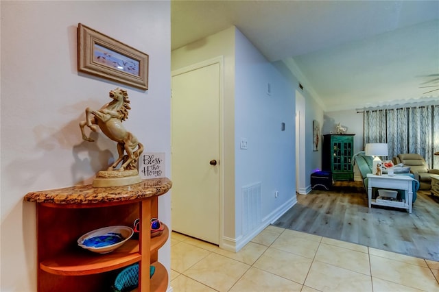 corridor featuring light tile patterned floors