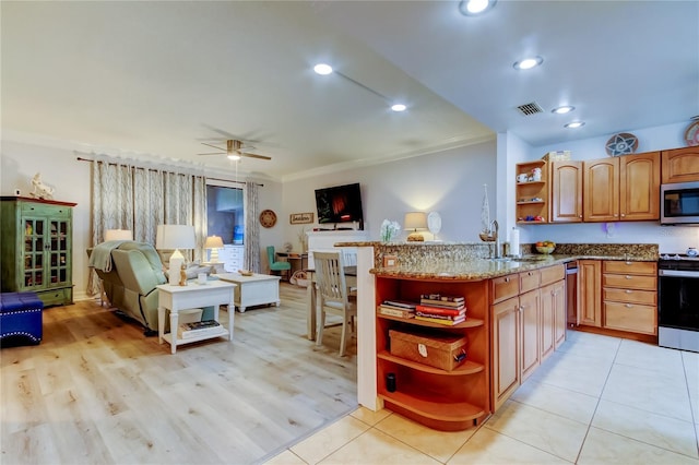 kitchen featuring sink, crown molding, ceiling fan, kitchen peninsula, and stainless steel appliances