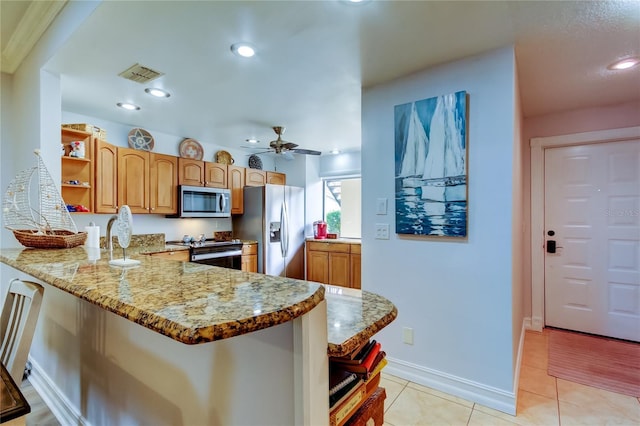 kitchen with light stone countertops, ceiling fan, stainless steel appliances, kitchen peninsula, and light tile patterned floors