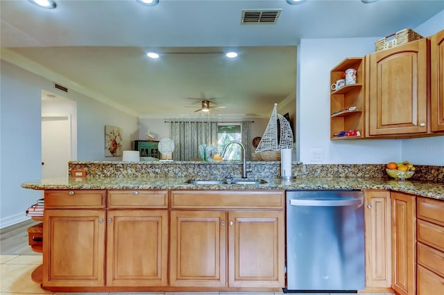 kitchen featuring ceiling fan, dishwasher, light stone counters, and sink