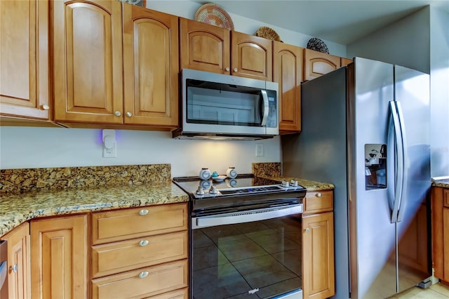 kitchen with light stone countertops and appliances with stainless steel finishes