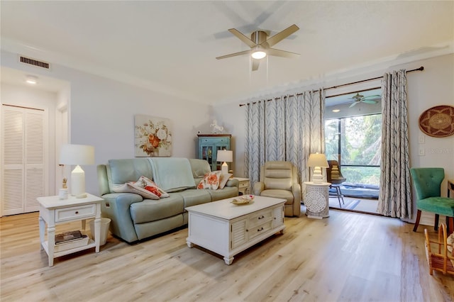 living room featuring ceiling fan and light hardwood / wood-style floors