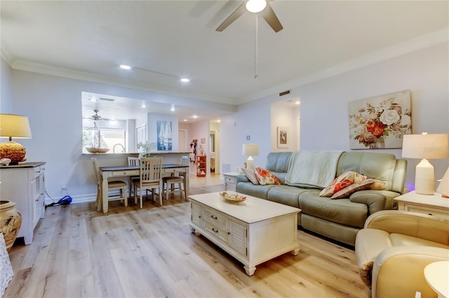 living room featuring light hardwood / wood-style floors, ceiling fan, and ornamental molding