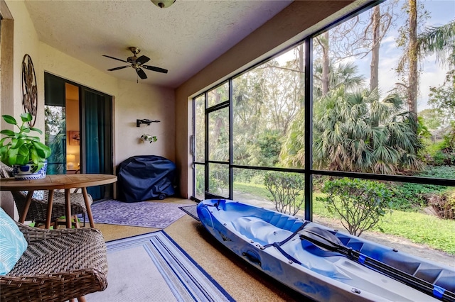 unfurnished sunroom featuring a jacuzzi and ceiling fan