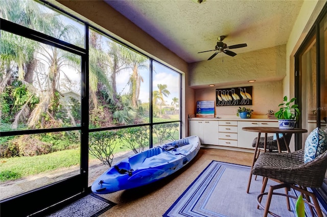 sunroom featuring ceiling fan