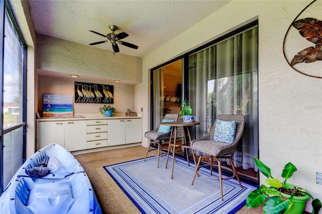 sunroom with ceiling fan