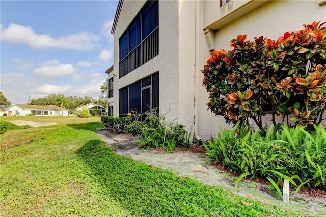 view of property exterior featuring a lawn