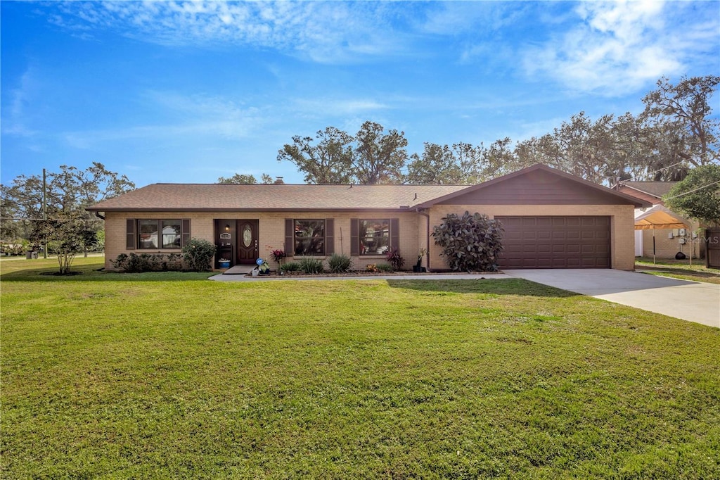 ranch-style home with a front lawn and a garage