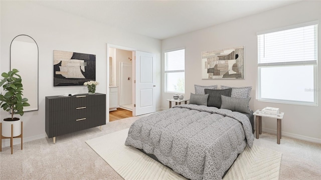 bedroom featuring carpet flooring, multiple windows, and connected bathroom