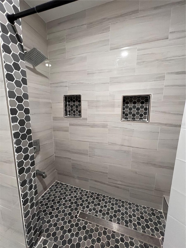 bathroom with tiled shower