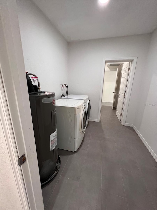 laundry room with washing machine and dryer and electric water heater