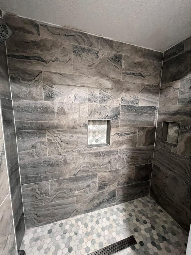 bathroom with a tile shower