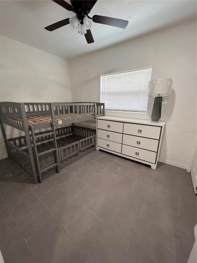 bedroom with dark tile patterned flooring and ceiling fan