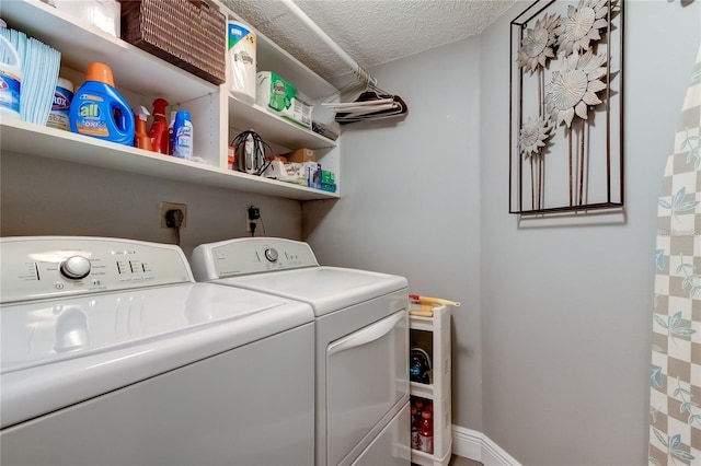 laundry area featuring separate washer and dryer and a textured ceiling