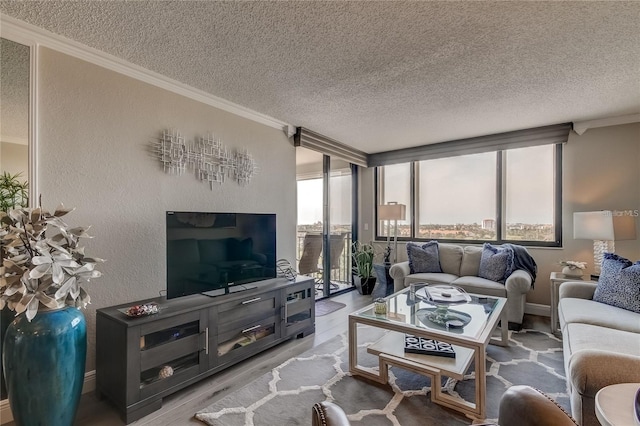 living room featuring ornamental molding, hardwood / wood-style floors, a textured ceiling, and a wealth of natural light