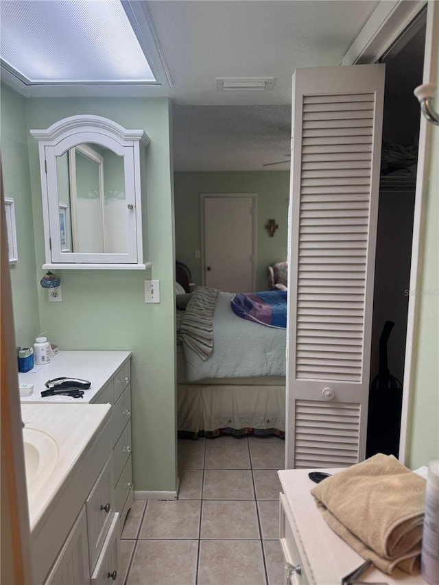 bathroom featuring tile patterned floors and vanity