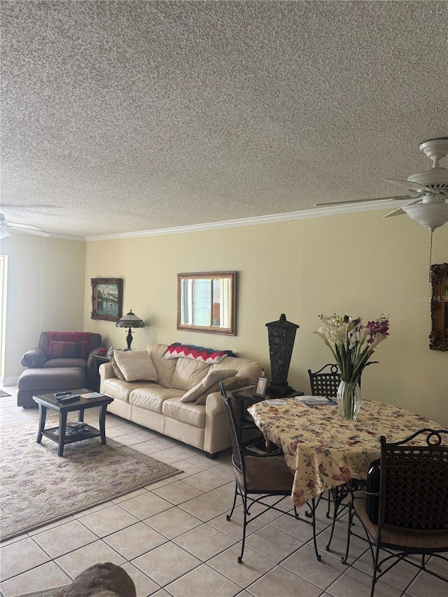 living room featuring light tile patterned floors, a textured ceiling, ceiling fan, and ornamental molding