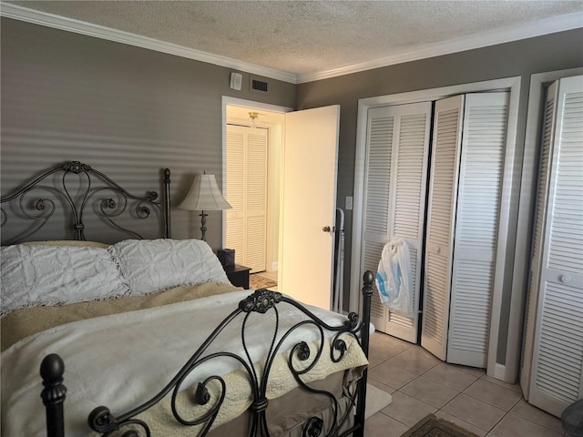 tiled bedroom with a textured ceiling and ornamental molding