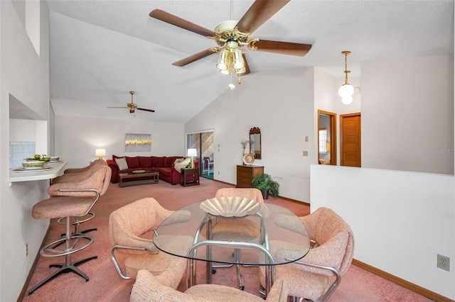 carpeted dining space with ceiling fan and lofted ceiling