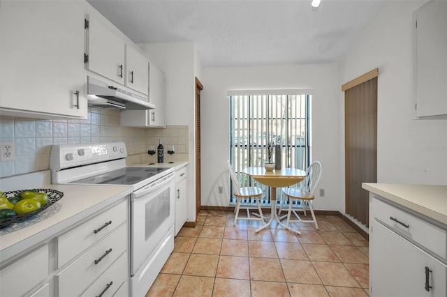 kitchen featuring decorative backsplash, white electric range, light tile patterned floors, and white cabinetry