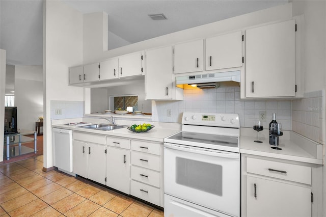 kitchen featuring decorative backsplash, white appliances, sink, light tile patterned floors, and white cabinetry