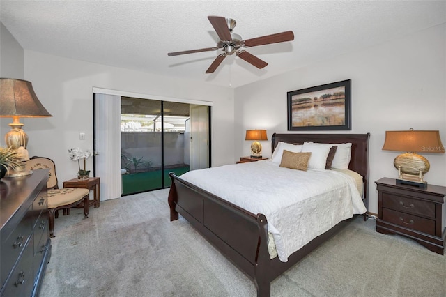 bedroom featuring ceiling fan, light colored carpet, a textured ceiling, and access to outside