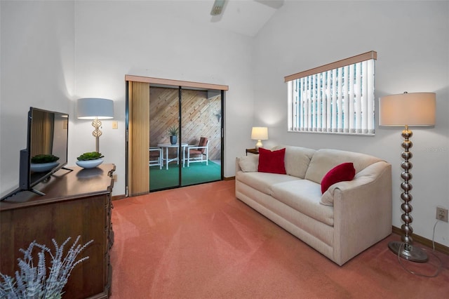 carpeted living room featuring high vaulted ceiling and ceiling fan