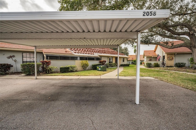 view of car parking featuring a yard and a carport