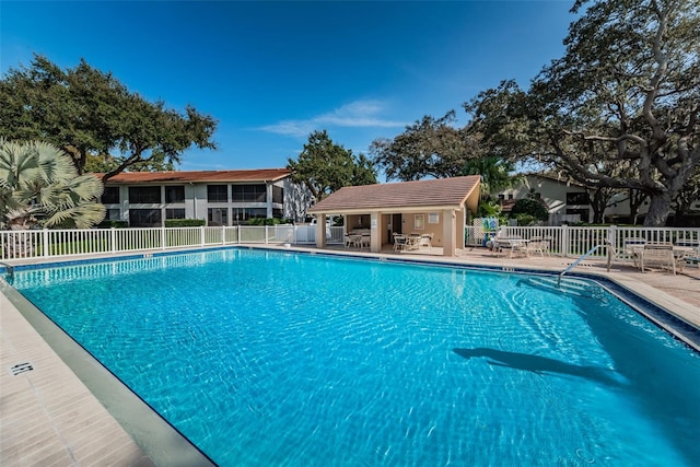 view of pool with an outbuilding and a patio area