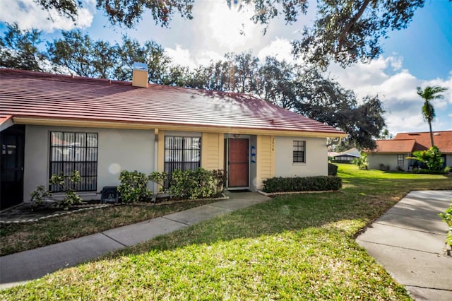 ranch-style home with a front lawn