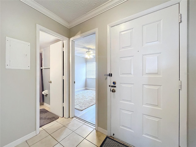 interior space featuring ceiling fan, electric panel, crown molding, a textured ceiling, and light tile patterned floors